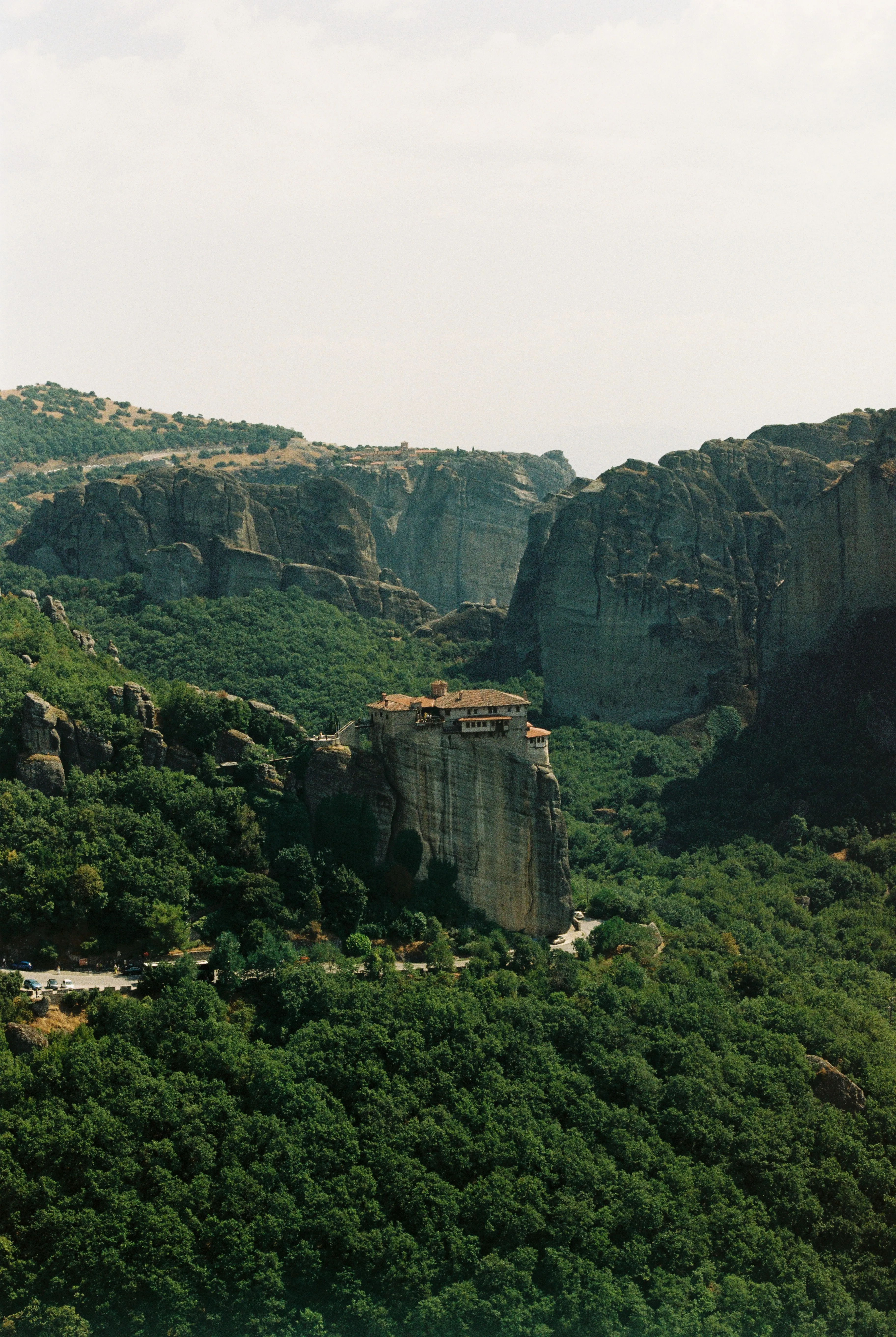 Cliff-top monastery among green hills