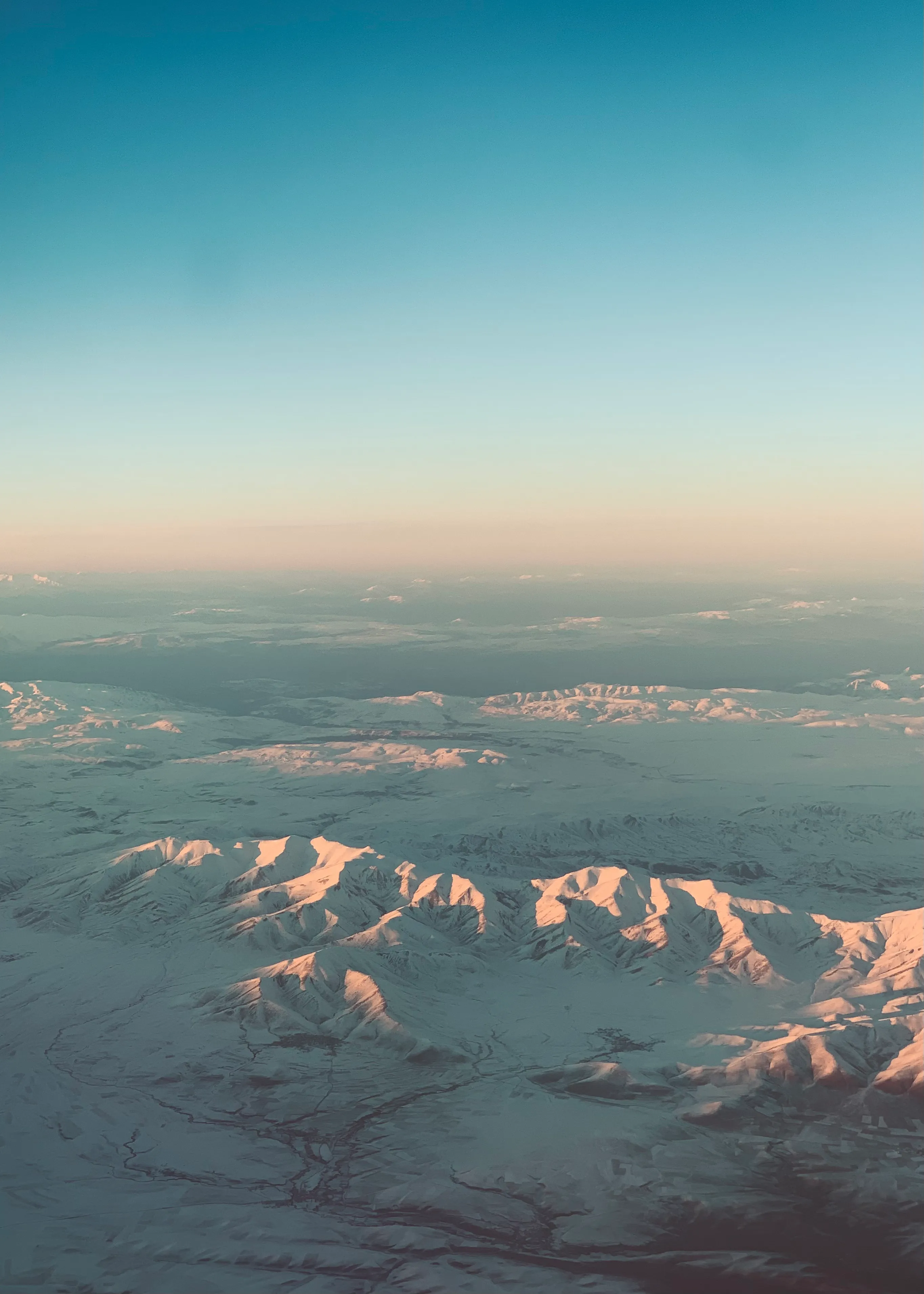 Snow-covered mountains seen from a plane window